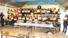 Racecourse Primary School pupils pose for a photo with BIC's Salome Ngugi and their teacher while holding their certificates. PHOTO/BIC